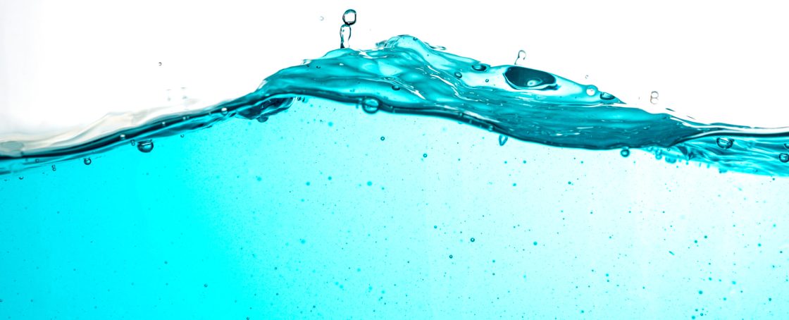 Blue,Water,Surface,With,Splash,,Waves,And,Air,Bubbles,On
