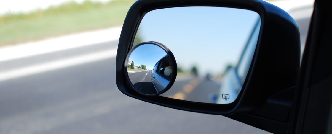 A,Round,Convex,Mirror,(in,Focus),Attached,To,A,Vehicle's